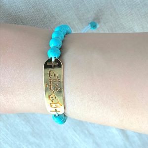 TURQUOISE BRACELET WITH A TAG IN ARABIC "Thy will be done"