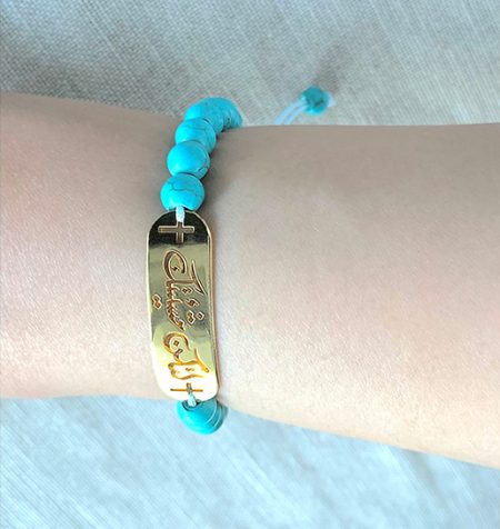 TURQUOISE BRACELET WITH A TAG IN ARABIC "Thy will be done"